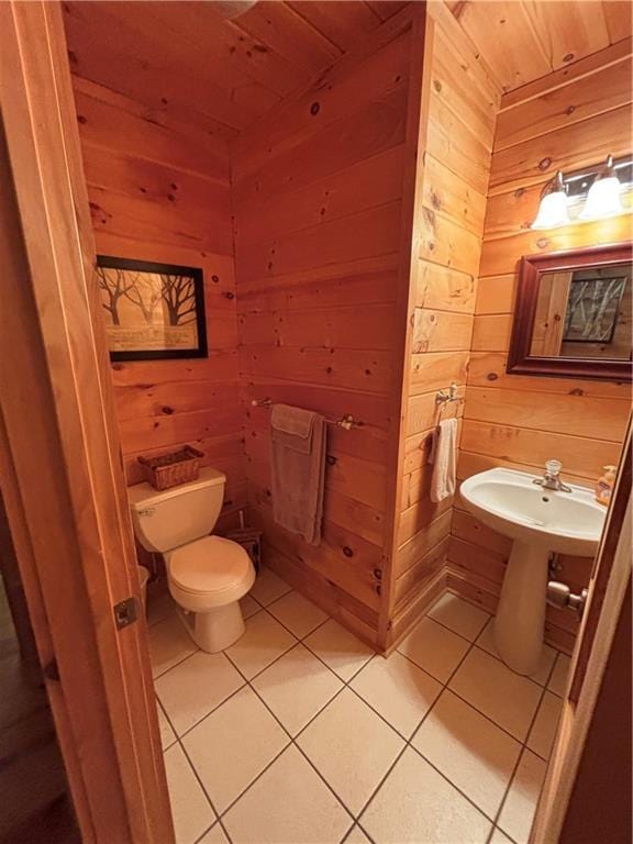 bathroom featuring wood walls, tile patterned floors, toilet, and wooden ceiling