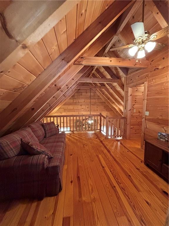 additional living space with vaulted ceiling with beams, wood ceiling, wooden walls, and wood-type flooring