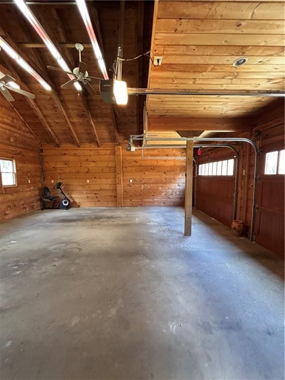 garage with a garage door opener and wooden walls