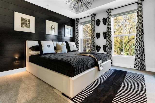 bedroom featuring multiple windows and wood walls