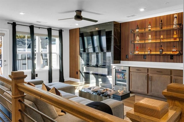 bar featuring ceiling fan, wine cooler, and light wood-type flooring