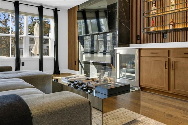 living room featuring beverage cooler and light hardwood / wood-style flooring