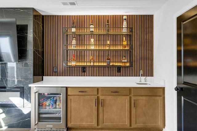 bar with beverage cooler and sink