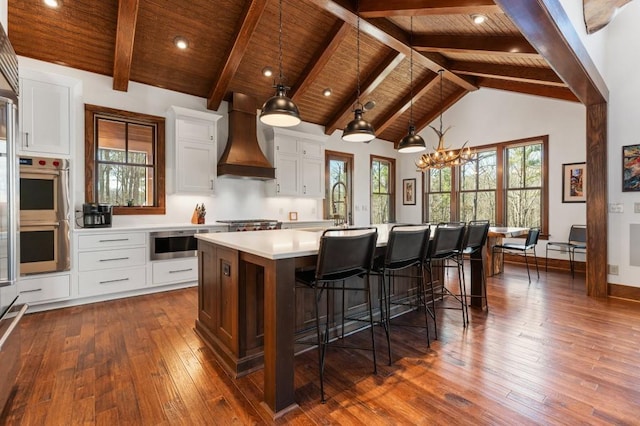 975 Blalock Lakes Dr, Newnan, GA 30263 - kitchen with wooden ceiling, premium range hood, double oven, and light countertops