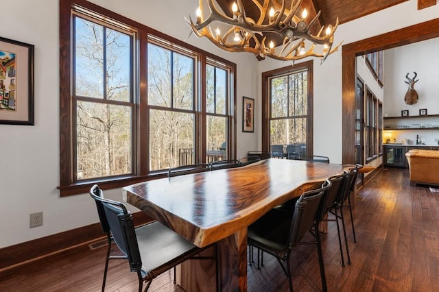 975 Blalock Lakes Dr, Newnan, GA 30263 - dining space featuring baseboards, visible vents, dark wood-style flooring, vaulted ceiling, and bar area