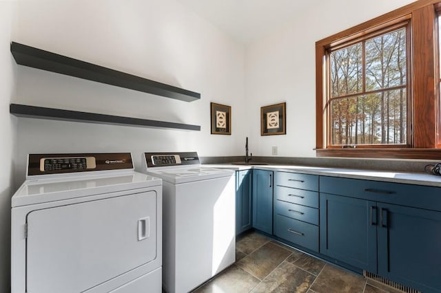 975 Blalock Lakes Dr, Newnan, GA 30263 - laundry area with cabinet space, washing machine and dryer, stone finish floor, and a sink