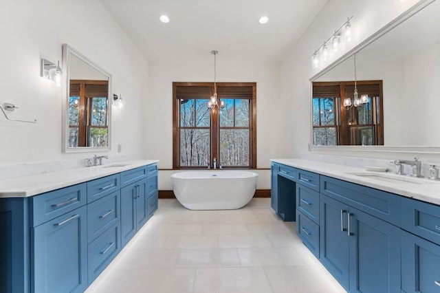 975 Blalock Lakes Dr, Newnan, GA 30263 - full bath with plenty of natural light, a chandelier, two vanities, and a sink