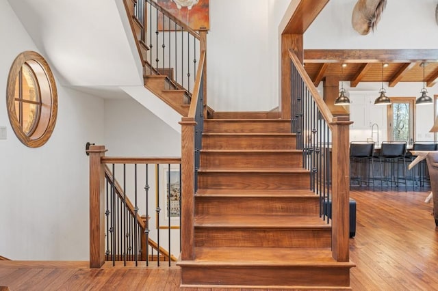 975 Blalock Lakes Dr, Newnan, GA 30263 - stairway featuring wood ceiling, beam ceiling, and hardwood / wood-style flooring