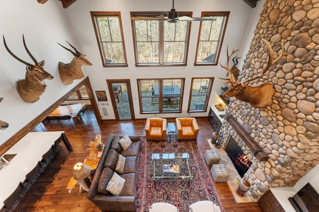 975 Blalock Lakes Dr, Newnan, GA 30263 - living room with a warm lit fireplace, a high ceiling, and wood finished floors