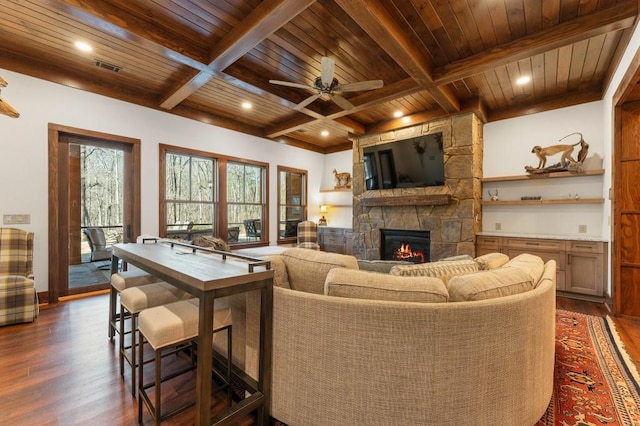 975 Blalock Lakes Dr, Newnan, GA 30263 - living room with wooden ceiling, dark wood finished floors, beam ceiling, and a stone fireplace
