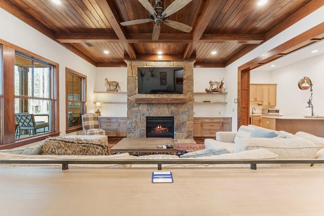 975 Blalock Lakes Dr, Newnan, GA 30263 - living room with ceiling fan, a stone fireplace, wooden ceiling, coffered ceiling, and beamed ceiling