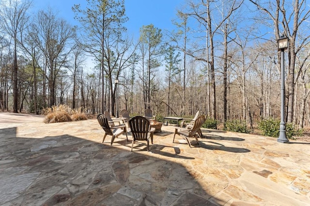 975 Blalock Lakes Dr, Newnan, GA 30263 - view of patio with an outdoor fire pit and a wooded view
