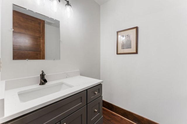 975 Blalock Lakes Dr, Newnan, GA 30263 - bathroom with vanity, baseboards, and wood finished floors