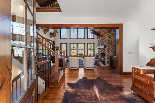 975 Blalock Lakes Dr, Newnan, GA 30263 - entryway with baseboards, a towering ceiling, stairway, hardwood / wood-style floors, and a stone fireplace