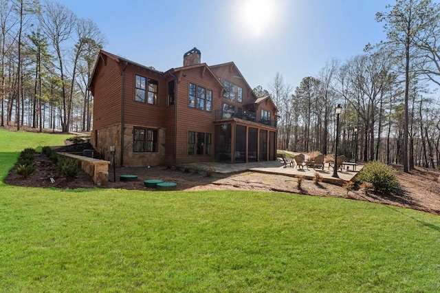 975 Blalock Lakes Dr, Newnan, GA 30263 - rear view of house with a patio, a lawn, a chimney, and a sunroom