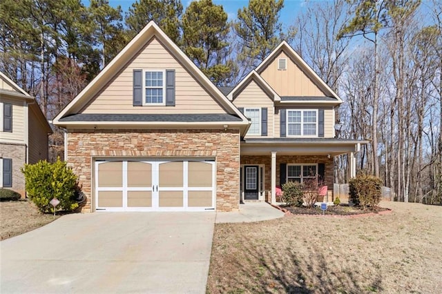 traditional home featuring board and batten siding, stone siding, driveway, and a garage