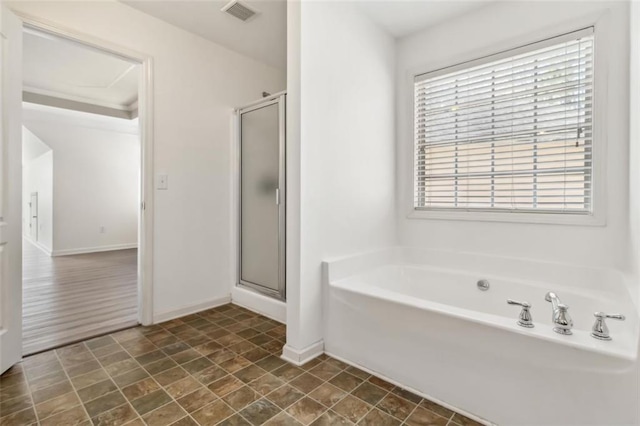 bathroom with a garden tub, a shower stall, visible vents, and baseboards