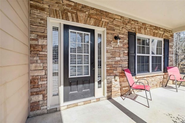 entrance to property with stone siding and brick siding