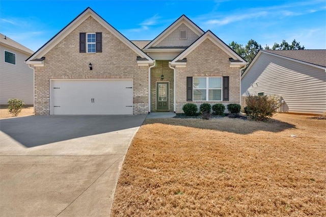 craftsman inspired home with a front lawn, an attached garage, brick siding, and driveway