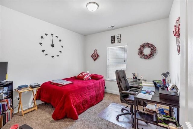 carpeted bedroom with visible vents and baseboards