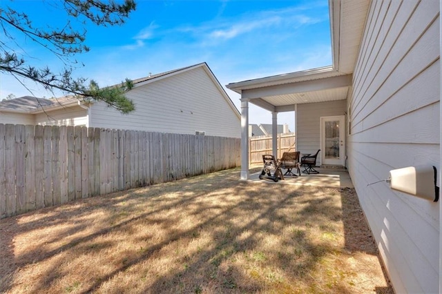 view of yard featuring a patio and a fenced backyard