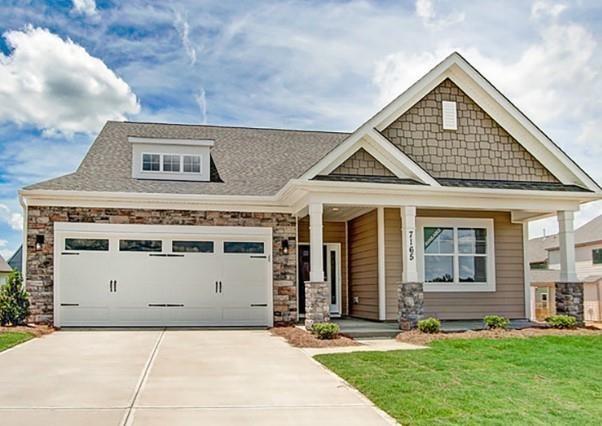 craftsman-style home with a garage and a front lawn