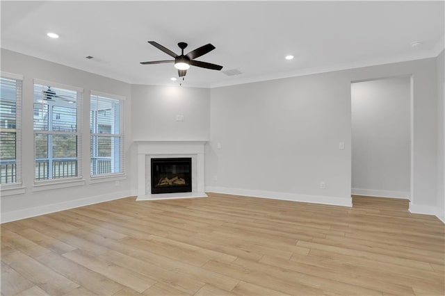 unfurnished living room with ceiling fan, ornamental molding, and light hardwood / wood-style floors