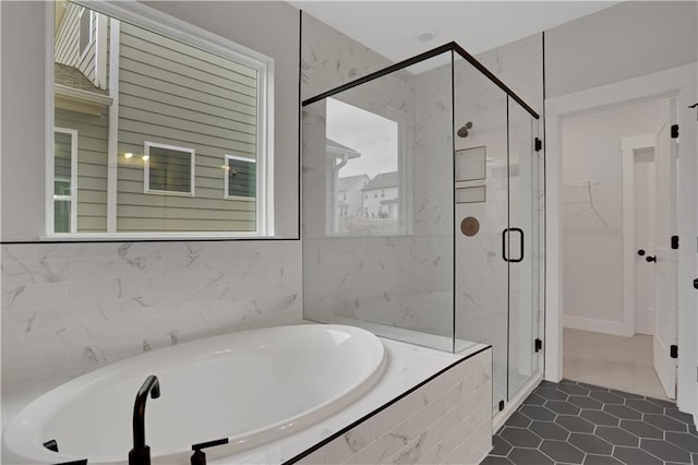 bathroom with separate shower and tub and tile patterned floors