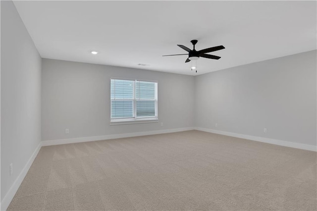 empty room featuring light carpet and ceiling fan