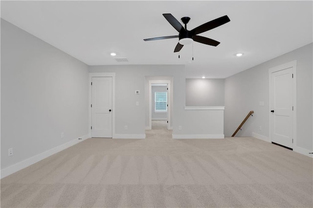 carpeted empty room featuring ceiling fan