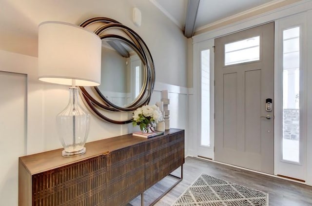 foyer entrance with beamed ceiling and hardwood / wood-style floors