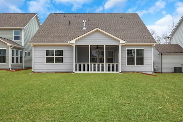 back of house with a sunroom, cooling unit, ceiling fan, and a lawn