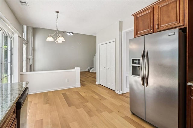 605 Alstonefield Dr, Alpharetta, GA 30004 - kitchen featuring appliances with stainless steel finishes, light wood-style flooring, a chandelier, and light stone countertops