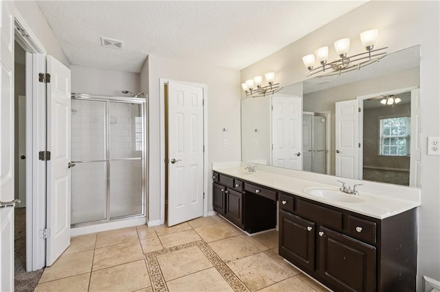 605 Alstonefield Dr, Alpharetta, GA 30004 - full bathroom featuring a chandelier, double vanity, a stall shower, a textured ceiling, and tile patterned floors