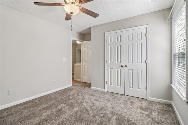 605 Alstonefield Dr, Alpharetta, GA 30004 - unfurnished bedroom featuring carpet, a textured ceiling, a closet, and a ceiling fan