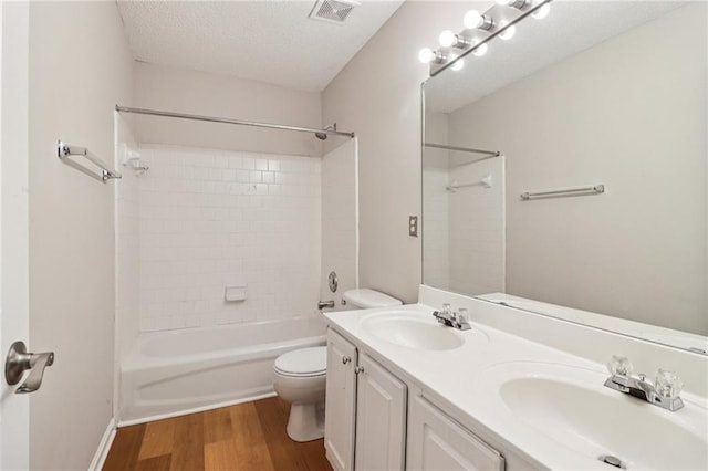 605 Alstonefield Dr, Alpharetta, GA 30004 - full bath with wood finished floors, double vanity, washtub / shower combination, and a textured ceiling