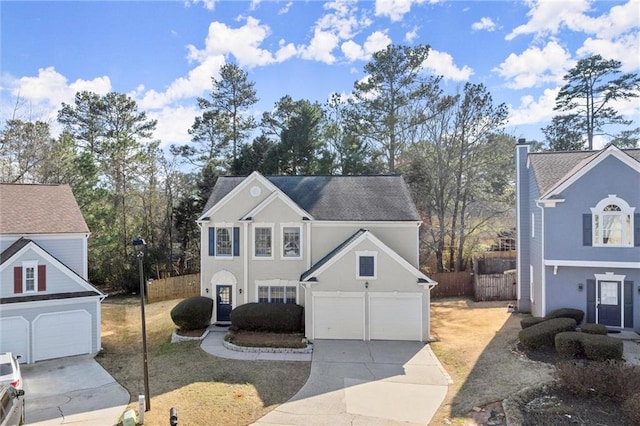 traditional home with stucco siding, concrete driveway, a garage, and fence