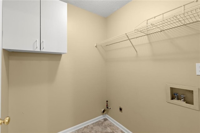 laundry room featuring baseboards, gas dryer hookup, hookup for a washing machine, cabinet space, and hookup for an electric dryer