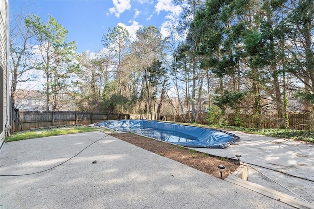 view of pool featuring a fenced backyard, a fenced in pool, and a patio