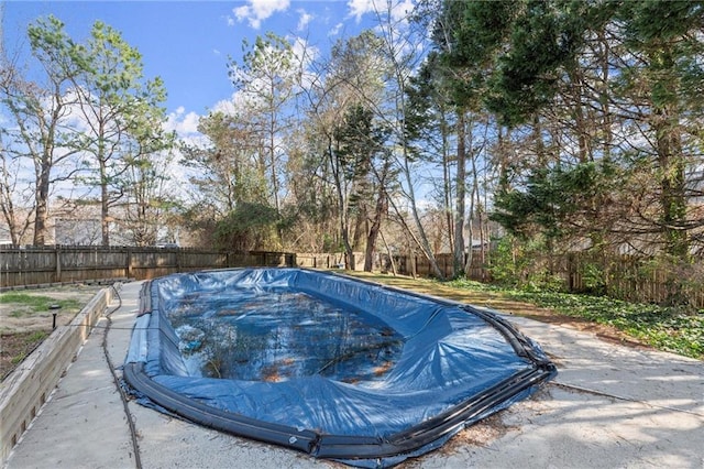 view of swimming pool with a fenced backyard