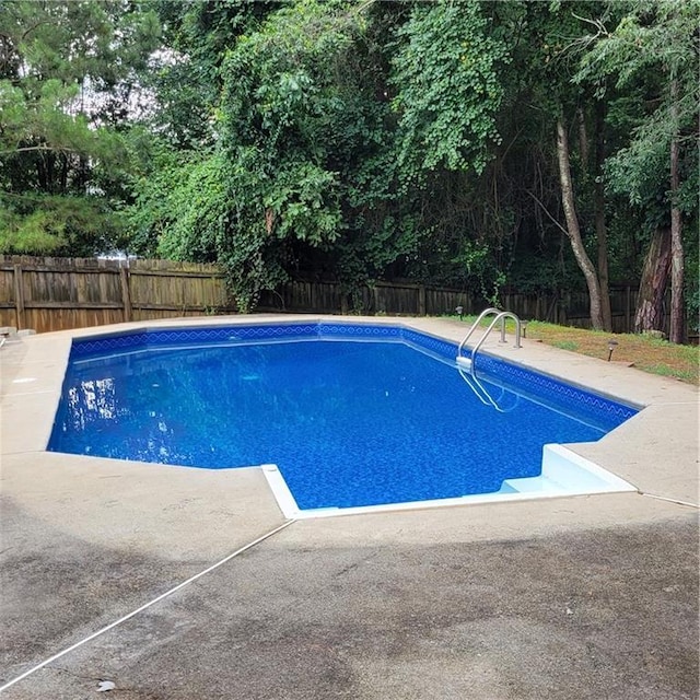 view of pool featuring a patio, a fenced in pool, and a fenced backyard