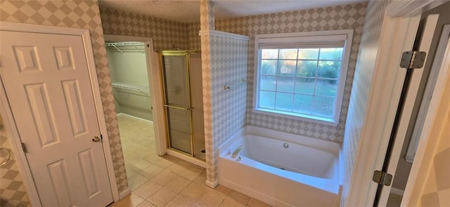 full bath with a spacious closet, a shower stall, a bath, tile patterned floors, and wallpapered walls