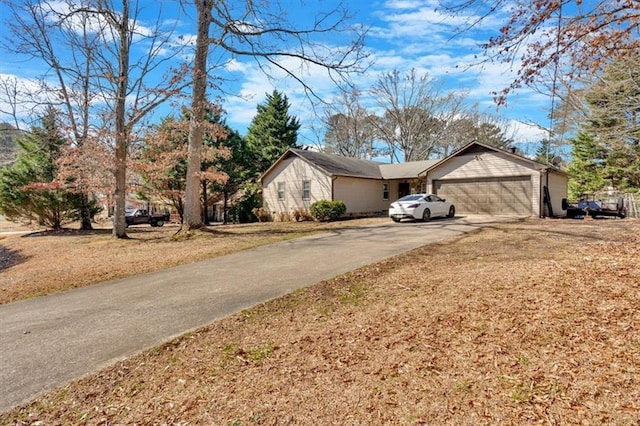 view of home's exterior with an attached garage and driveway