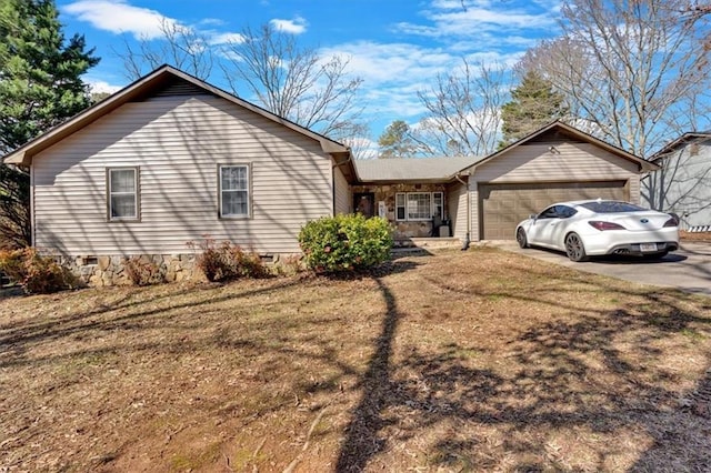 ranch-style home featuring driveway, crawl space, and an attached garage