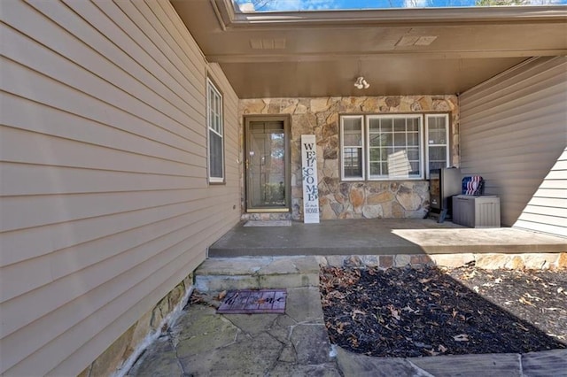 property entrance featuring stone siding