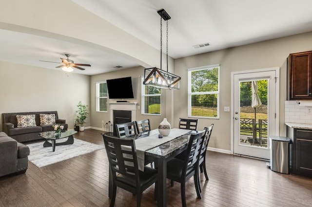 dining room featuring ceiling fan and dark wood-type flooring