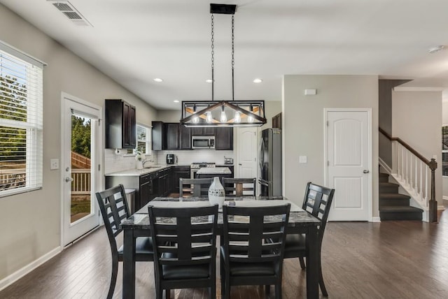 dining room featuring dark wood-type flooring and sink