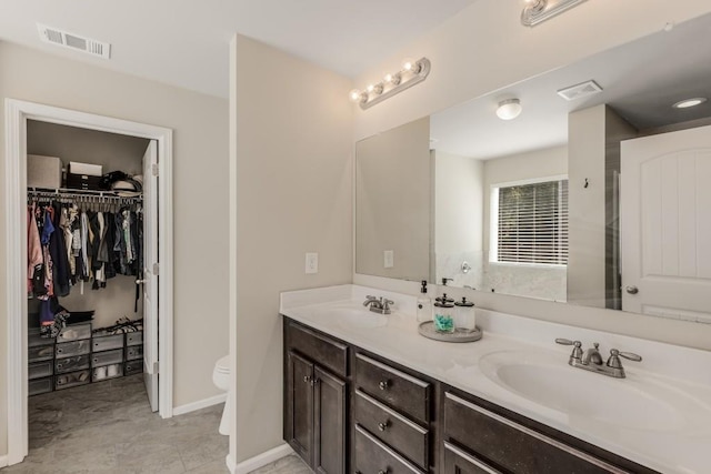 bathroom featuring vanity and toilet