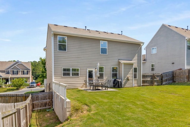 back of house featuring a yard and a patio