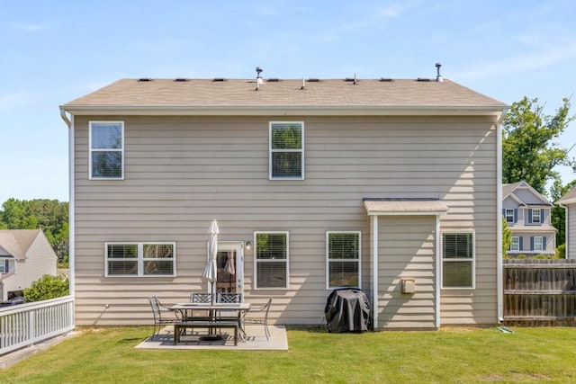 back of property featuring a lawn and a patio area